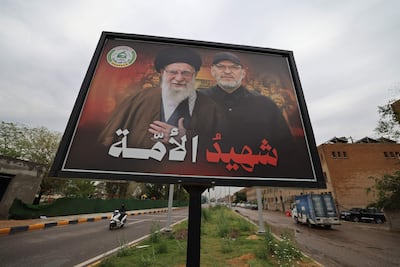 A billboard on a street in Baghdad shows Iran's late supreme leader, Ayatollah Ali Khamenei, and Hashim Al Saraji, leader of the Iran-backed Iraqi militia Kataib Sayyid Al Shuhada. AFP