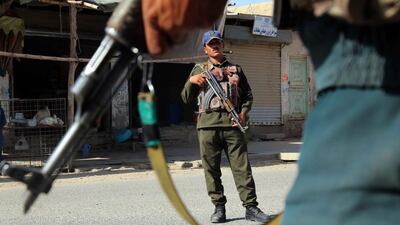 Afghan security officials stand guard at a check point in Kandahar, Afghanistan. Muhammad Sadiq / EPA