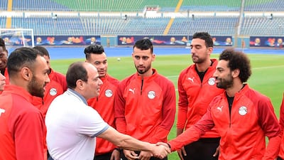 Egyptian President Abdel Fattah El Sisi greets Egypt's UEFA Champions League winning Liverpool forward Mohamed Salah during the national team's training camp at the 30 June Stadium in Cairo on June 15, 2019. AFP