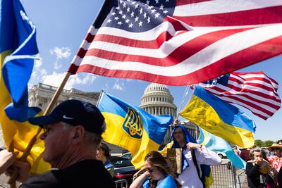Supporters of Ukraine wave US and Ukrainian flags outside the US Capitol on April 21 after the House of Representatives approved foreign aid packages to Ukraine, Israel and Taiwan. EPA