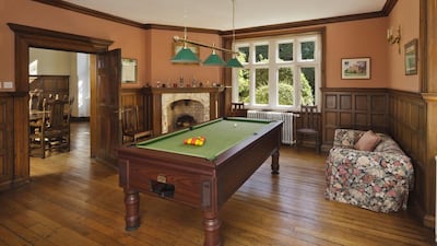 On the ground level, a drawing room with large glazed windows opens into the billiards room. Courtesy Cheffins