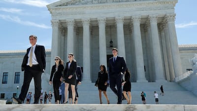 People walk out after the US Supreme Court granted parts of the Trump administration's emergency request to put his travel ban into effect immediately while the legal battle continues in Washington, US, June 26, 2017. RYuri Gripas / AFP