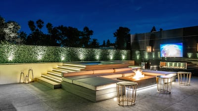 An outdoor seating area with screens and a firepit.