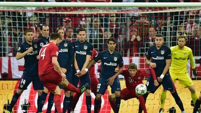 Bayern Munich’s Spanish midfielder Xabi Alonso, left, scores the opening goal during the UEFA Champions League semi-final, second leg against Atletico Madrid in Munich, southern Germany, on May 3, 2016. John MacDougall / AFP