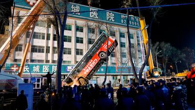 A crane lifts out the bus. AFP
