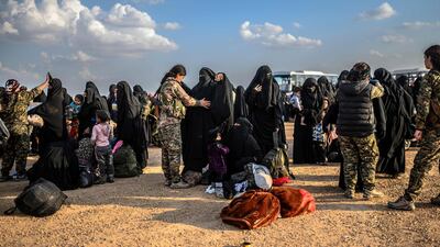 Women are searched by Syrian Democratic Forces after fleeing ISIS's last holdout of Baghouz, Syria on February 22, 2019. AFP