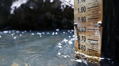 A gauge measures water levels on the Rio Nambe amid extreme drought in New Mexico. The world has warmed nearly 1.2°C so far — enough to usher in deadly heatwaves, floods and storm surges made worse by rising seas. Photo: Getty