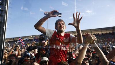 A fan tries to take a photo of the podium ceremony after the Australian Grand Prix on Sunday in Melbourne. Jason Reed / Reuters