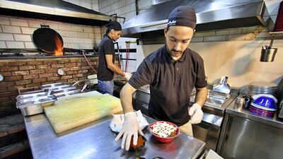 Members of staff prepare the meals as orders begin for the day. Courtesy Charlie Faulkner