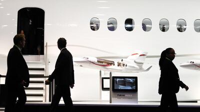 Visitors walk past aircraft replicas at the Dassault stand at the European Business Aviation Convention and Exhibition. Pierre Albouy / Reuters