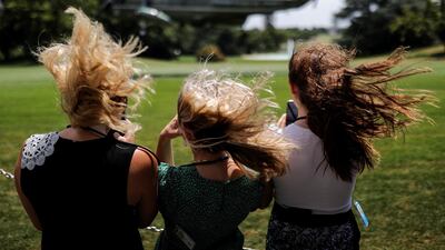 Visitors withstand a strong gust of wind created by Marine One as they watch the helicopter ascend with US President Donald Trump aboard departing for travel to Atlanta, Georgia, from the South Lawn at the White House in Washington. Reuters