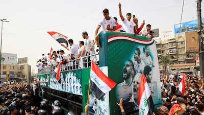 Iraqi players greet fans during a public reception in Baghdad after qualifying for the Fifa World Cup for the first time since 1986. Reuters