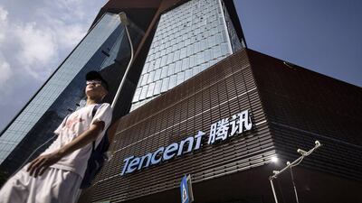 Tencent’s new headquarters in Shenzhen, left; and a Made in China clothes tag. The bulk of electronic and consumer goods exported from China are either unbranded or produced for foreign companies such as Apple. Qilai Shen / Bloomberg; Brent Lewin / Bloomberg