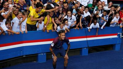 Neymar poses for a photograph with the fans during his presentation at the Parc des Princes. John Schults / Reuters