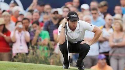 Rory McIlroy of Northern Ireland lines up his putt on the 18th green.