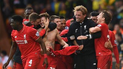 Liverpool’s Adam Lallana celebrates with teammates and manager Jurgen Klopp after scoring the winner in a 5-4 Premier League victory on Saturday. Jon Buckle / PA / AP
