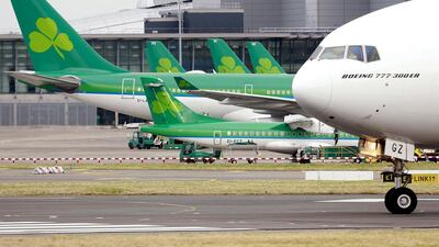 Aer Lingus planes are parked at their stand at Dublin airport. Etihad Airways had accumulated a 4 per cent stake in Aer Lingus before it exited in the IAG takeover. Cathal McNaughton / Reuters