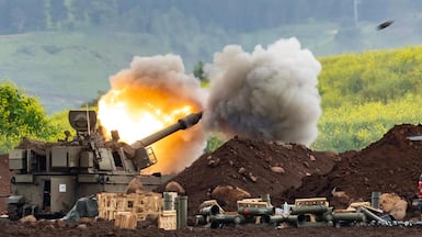 An Israeli gun fires fires towards southern Lebanon during escalating cross-border fighting, as diplomatic efforts seek to prevent a wider war. AFP