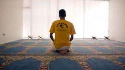 The lifeguard Khaled Sherbini prays in a mosque near the beach in Abu Dhabi.