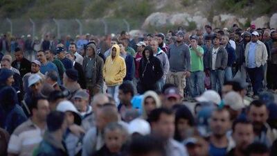 Palestinian labourers wait to cross into Israel at a checkpoint near the West Bank village of Nilin. Palestinian leaders say a US offer of billions in aid won't solve the conflict with Israel.