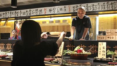 The Japanese chain Inakaya’s new restaurant, in Abu Dhabi’s Venetian Village, offers traditional robatayaki dishes, served on long paddles. Lee Hoagland / The National