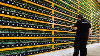 Two technicians inspect bitcoin mining at Bitfarms in Saint Hyacinthe, Quebec - Cryptocurrencies dropped sharply for the second time in less than 24 hours. AFP