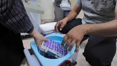 Refrigerated Pfizer-BioNTech coronavirus vaccines being unpacked at an inoculation centre in Baghdad.