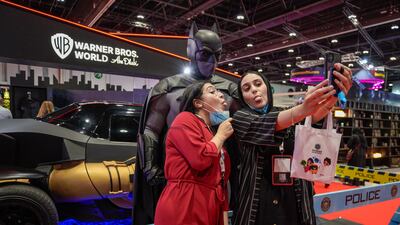 Comic Con visitors pose with Batman.