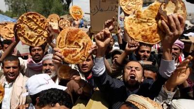 Protesters hold loaves of bread bearing words in Arabic for 'leave' during a demonstration in Sana'a yesterday.