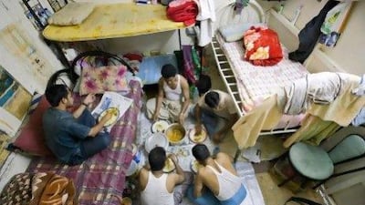 Five Bangladeshi men have supper in a room at " Bachelor's Building"Five Bangladeshis have supper in a room at the ‘Bachelor’s Building’, a block of flats where only male expatriates workers can live.