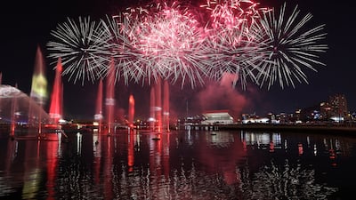 A two-for-one show took place at Dubai Festival City Mall – a fireworks display and the Imagine light show on the promenade. Pawan Singh / The National