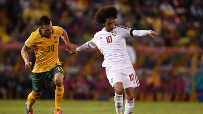Australia's Trent Sainsbury, left, chases down UAE's Omar Abdulrahman during the Asian Cup semi-final. Paul Miller / EPA
