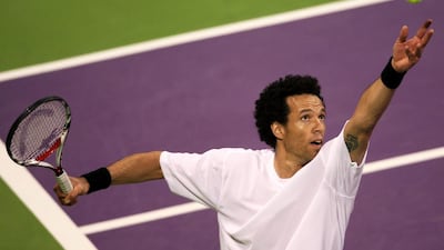 Morocco's Younes El Aynaoui serves to Ryler Deheart of the United States during the Qatar Open in Doha, Qatar, on January 5, 2010. Hassan Ammar / AP Photo