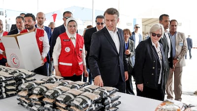 Mr Macron visits Egyptian Red Crescent warehouses storing aid for Gaza in the border town of El-Arish. AFP