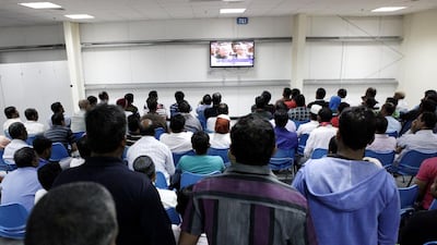 Workers watch television in one of the recreation centres. Christopher Pike / The National