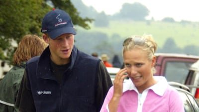 Zara Phillips, wearing a denim skirt and a pink rugby shirt, walks with cousin Prince Harry at the Gatcombe Horse Trials on August 8, 2004. Getty Images