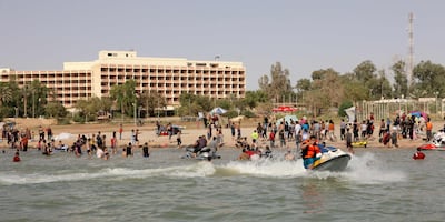 In this 2012 photo, Iraqis swim and ride jetskis on Lake Habbaniyah, in Anbar. AFP