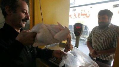 An Iranian man buys fresh chicken in Tehran. The price of chicken has now soared to Dh20 per kilo – three times the price it was a year ago.