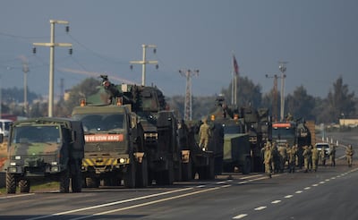 In this February 14, 2020, file photo, Turkish troops and artillery prepare to enter Syria, in Reyhanli, Hatay, Turkey. AP