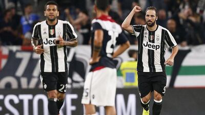 Juventus' Gonzalo Higuain, right, and Dani Alves, left, celebrate after a goal on Wednesday night. Marco Bertorello / AFP / September 21, 2016