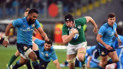 Ireland flanker Jordi Murphy, second right, runs past Italy fly-half Kelly Haimona, left, during their Six Nations match at the Olympic Stadium in Rome on February 7, 2015. Gabriel Bouys / AFP
