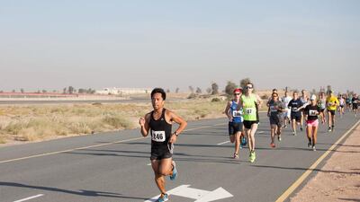 Participants run through the desert from the starting point of the Sevens Stadium during the Dubai Desert Road Run. There are multiple Desert Road Runs throughout the year with the intention of runners being able to track their progress throughout the year. Clint McLean for The National
