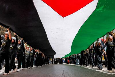 People march with a giant Palestinian flag during a demonstration commemorating the 78th anniversary of the Nakba, the 1948 displacement of Palestinians during the creation of Israel, in the city of Ramallah in the occupied West Bank. AFP
