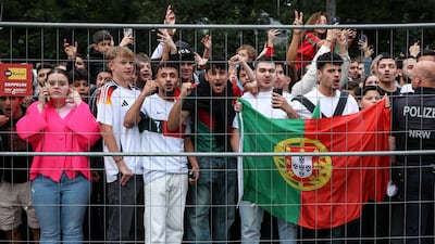 Portugal fans cheer as their national team arrives at Harsewinkel, in north-west Germany. EPA