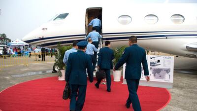 Soldiers walk to a Gulfstream G650ER business aircraft at the Airshow China 2014. Johannes Eisele / AFP