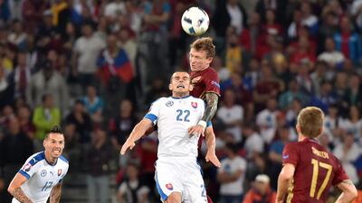 Russia’s midfielder Oleg Shatov vies for the header with Slovakia’s midfielder Viktor Pecovsky (front) during the Euro 2016 group B football match between Russia and Slovakia at the Pierre-Mauroy Stadium in Villeneuve-d’Ascq, near Lille, on June 15, 2016. / AFP / PHILIPPE HUGUEN