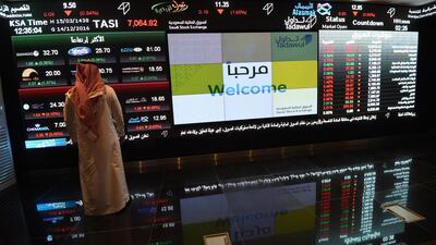 An investor looks at a screen of asset prices at the Tadawul exchange in Saudi Arabia. AFP