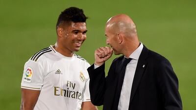 Zinedine Zidane jokes with Casemiro. Getty