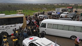 Security personnel and officials gather at the scene of an exchange of prisoners between Syrian authorities and Druze fighters, in Sweida city. AFP
