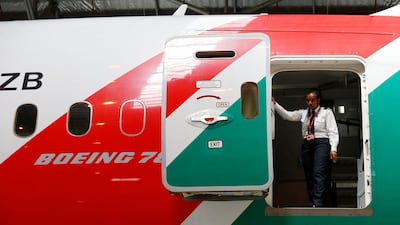 A Kenya Airways staff member is seen at the rear door of a Boeing Dreamliner 787-8. The airline has revived plans to expand its network by proposing to buy as many as 10 Boeing 737 Max aircraft. Thomas Mukoya / Reuters